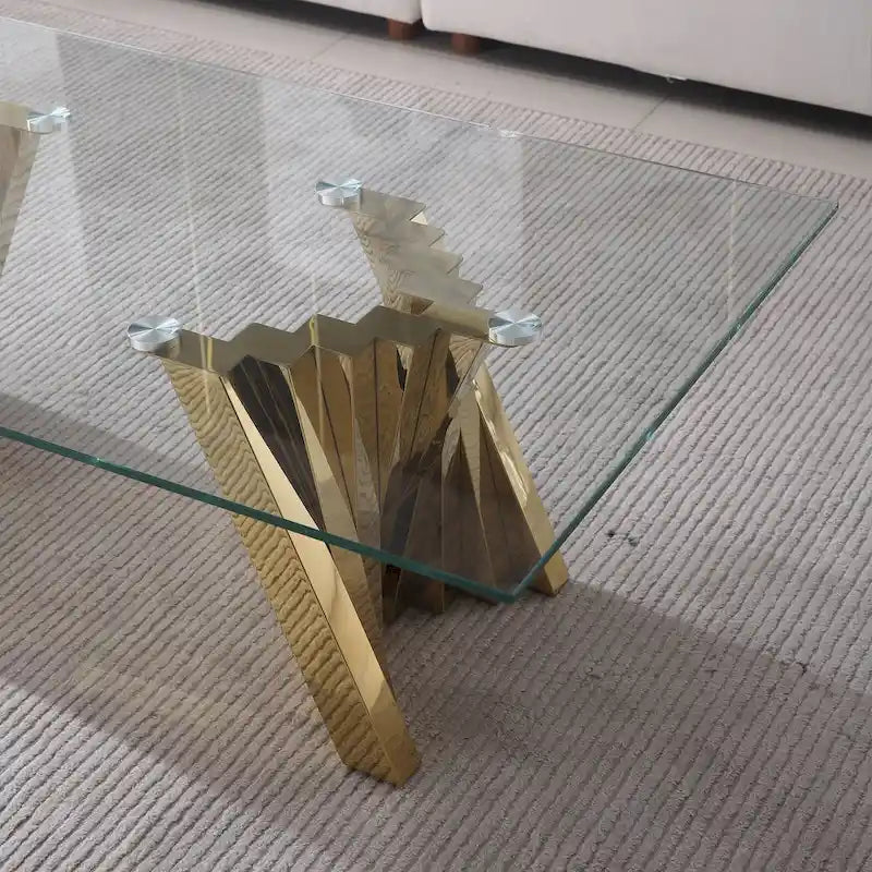 Table basse avec plateau en verre trempé et piètement en acier inoxydable finition miroir doré